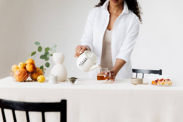 woman pouring a cup of afternoon tea